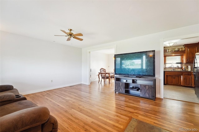 5142 Buffalo Rd, Erie, CO 80516 - living area with light wood-style floors, baseboards, and a ceiling fan