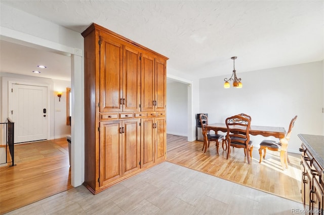 5142 Buffalo Rd, Erie, CO 80516 - dining space with a chandelier, light wood-style floors, and baseboards