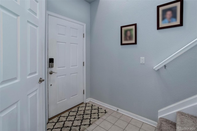 doorway to outside with light tile patterned floors