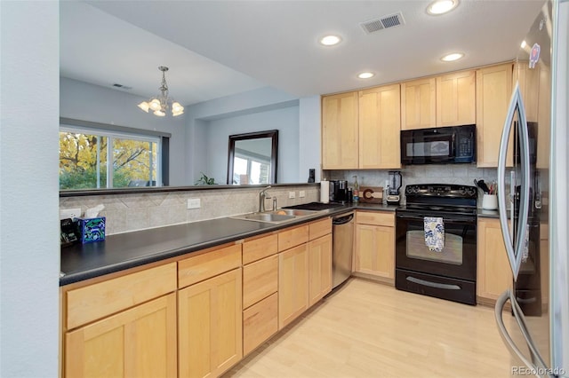 kitchen with backsplash, light hardwood / wood-style flooring, black appliances, a notable chandelier, and sink