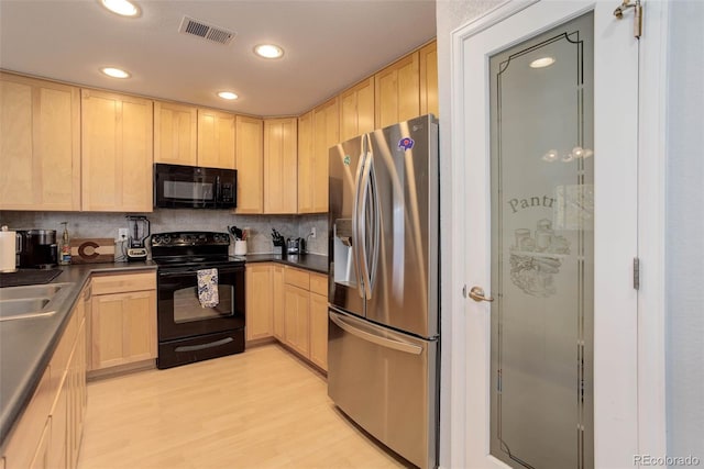 kitchen with light brown cabinets, black appliances, and light wood-type flooring