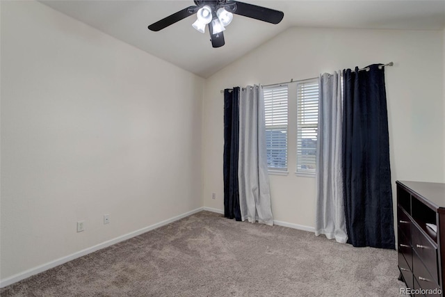 unfurnished room featuring vaulted ceiling, light carpet, and ceiling fan