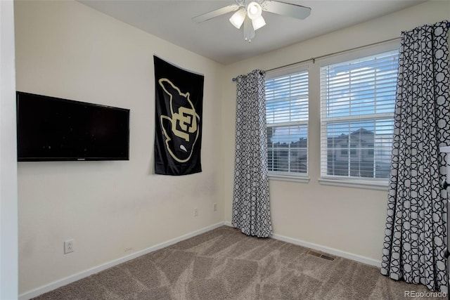 spare room with ceiling fan and carpet floors