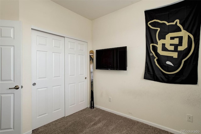 unfurnished bedroom with a closet and carpet flooring