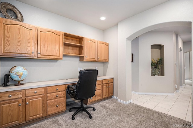 home office featuring light carpet, built in study area, recessed lighting, baseboards, and light tile patterned floors