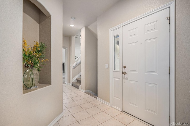 foyer entrance featuring baseboards, recessed lighting, stairs, and light tile patterned floors