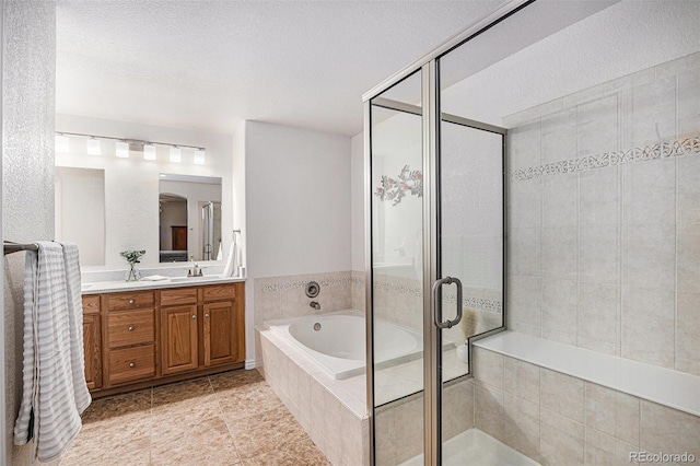 bathroom featuring a stall shower, a bath, and vanity