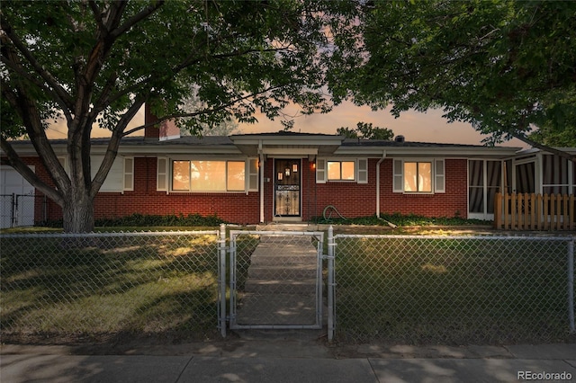 1280 Xanadu St, Aurora, CO 80011 - ranch-style house featuring brick siding, a fenced front yard, and a gate