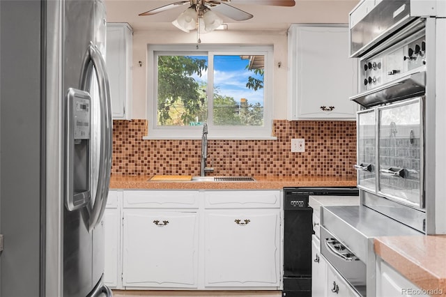 1280 Xanadu St, Aurora, CO 80011 - kitchen with appliances with stainless steel finishes, a ceiling fan, light countertops, and white cabinets
