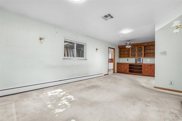 1280 Xanadu St, Aurora, CO 80011 - unfurnished living room with a baseboard radiator, light carpet, and a ceiling fan