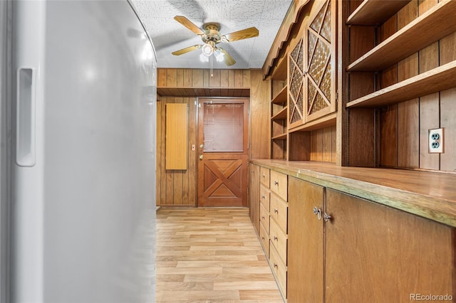 1280 Xanadu St, Aurora, CO 80011 - hallway with light wood-style flooring and wooden walls