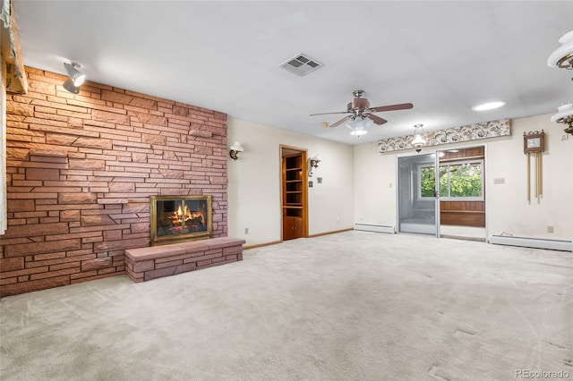 1280 Xanadu St, Aurora, CO 80011 - unfurnished living room with a baseboard heating unit, a ceiling fan, carpet flooring, and a stone fireplace