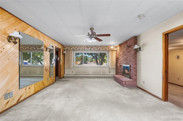 1280 Xanadu St, Aurora, CO 80011 - unfurnished living room with baseboard heating, a baseboard radiator, a ceiling fan, healthy amount of natural light, and wood walls