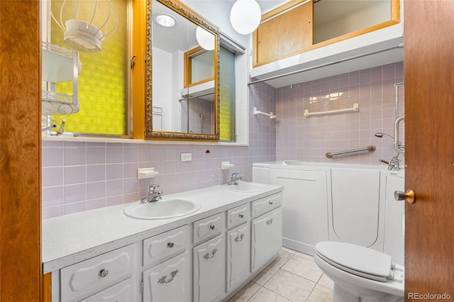 1280 Xanadu St, Aurora, CO 80011 - full bathroom featuring double vanity, decorative backsplash, tile patterned flooring, shower / washtub combination, and tile walls