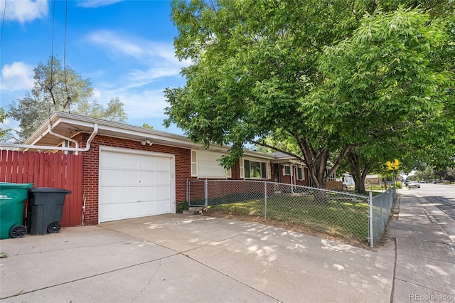 1280 Xanadu St, Aurora, CO 80011 - ranch-style house with brick siding, a garage, and driveway