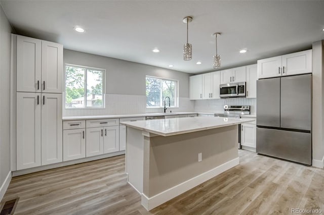 363 Lima St, Aurora, CO 80010 - kitchen with appliances with stainless steel finishes, backsplash, light countertops, a sink, and white cabinets