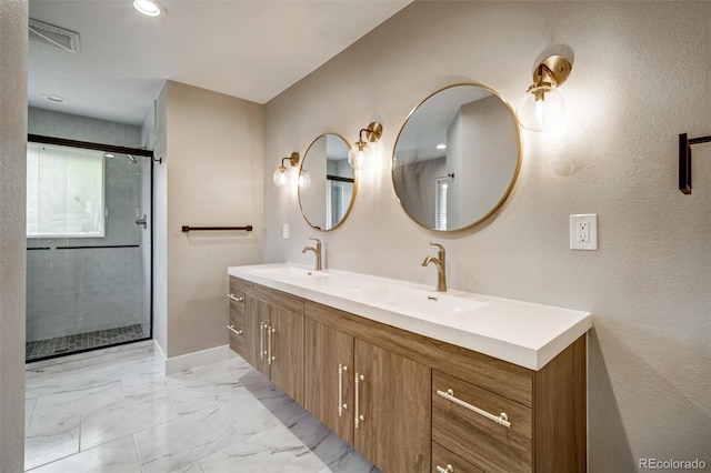 363 Lima St, Aurora, CO 80010 - full bathroom with double vanity, marble look tiles, an enclosed shower, baseboards, and recessed lighting