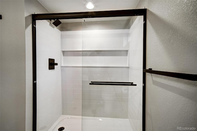 363 Lima St, Aurora, CO 80010 - full bathroom with a textured wall and a stall shower