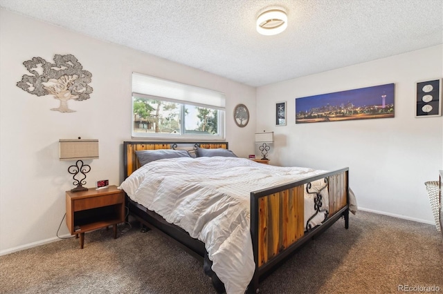 carpeted bedroom featuring baseboards and a textured ceiling