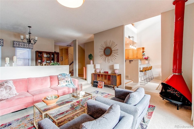 carpeted living room featuring a notable chandelier