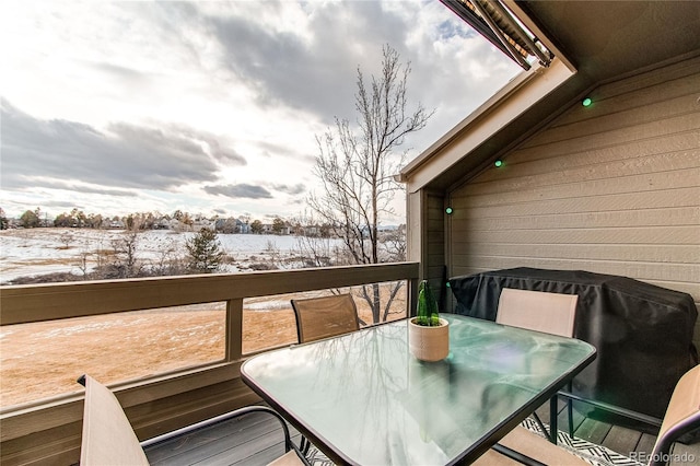 view of snow covered back of property