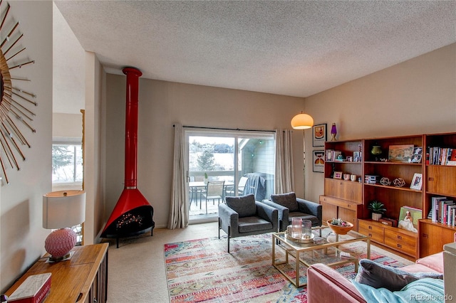 carpeted living room featuring a healthy amount of sunlight and a textured ceiling