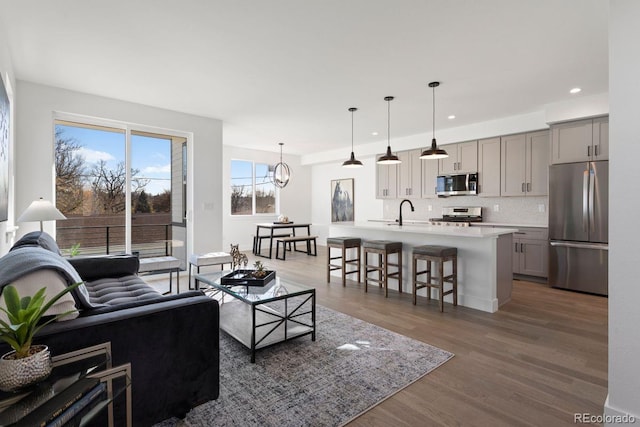 4650 W 9th Ave, Denver, CO 80204 - living area featuring recessed lighting, wood finished floors, and a chandelier