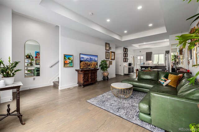 2824 W Parkside Pl, Denver, CO 80221 - living room featuring baseboards, wood finished floors, a tray ceiling, and recessed lighting