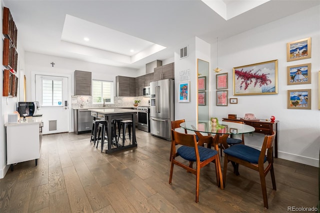 2824 W Parkside Pl, Denver, CO 80221 - dining area with dark wood-style floors, baseboards, visible vents, recessed lighting, and a raised ceiling