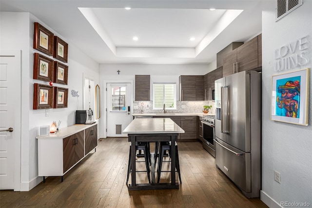 2824 W Parkside Pl, Denver, CO 80221 - kitchen with dark wood-style flooring, visible vents, high end appliances, light countertops, and a raised ceiling