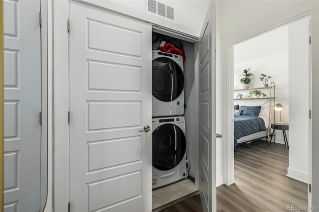 2824 W Parkside Pl, Denver, CO 80221 - clothes washing area with stacked washer / dryer, laundry area, wood finished floors, visible vents, and baseboards