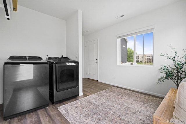 18645 E 54th Pl, Denver, CO 80249 - laundry room featuring washing machine and clothes dryer, wood finished floors, and baseboards