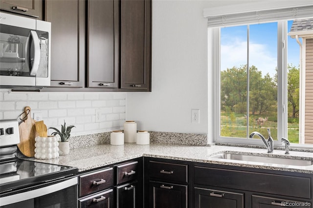 18645 E 54th Pl, Denver, CO 80249 - kitchen featuring stainless steel electric range oven, a sink, plenty of natural light, and backsplash