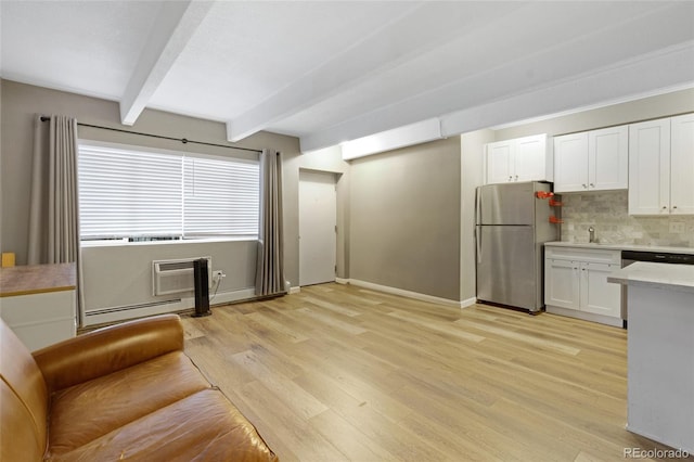 kitchen featuring white cabinets, stainless steel appliances, backsplash, light wood-type flooring, and beam ceiling