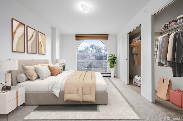 7801 W 35th Ave Unit 406, Wheat Ridge, CO 80033 - bedroom with light colored carpet and a baseboard radiator