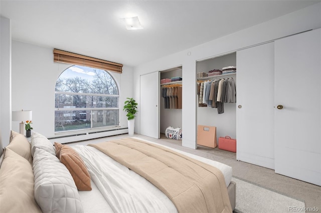 7801 W 35th Ave Unit 406, Wheat Ridge, CO 80033 - bedroom with carpet flooring, a baseboard radiator, and multiple closets