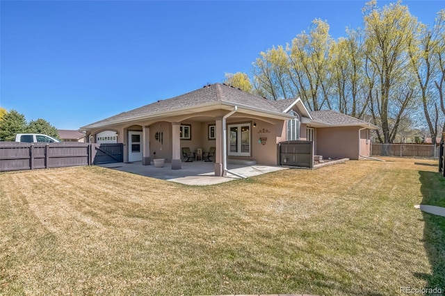 rear view of property featuring a fenced backyard, stucco siding, a patio, a gate, and french doors