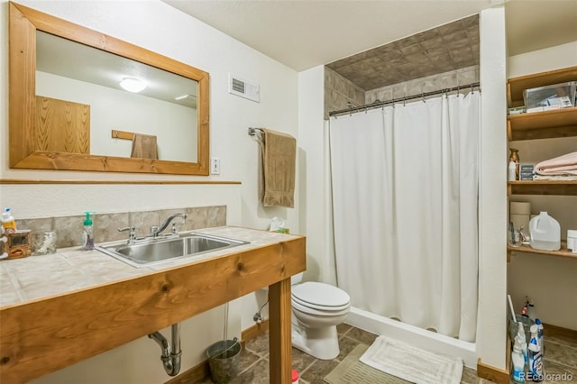 bathroom featuring a shower stall, visible vents, a sink, and toilet