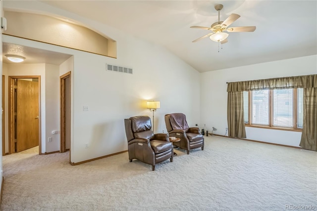 sitting room with visible vents, baseboards, ceiling fan, light carpet, and lofted ceiling