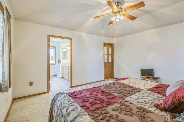 carpeted bedroom featuring baseboards and connected bathroom