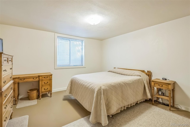 bedroom with baseboards, carpet, and a textured ceiling