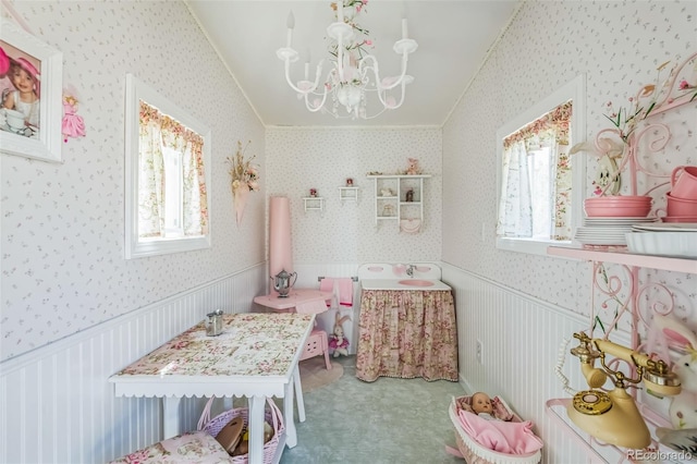 carpeted bedroom featuring a notable chandelier and wallpapered walls
