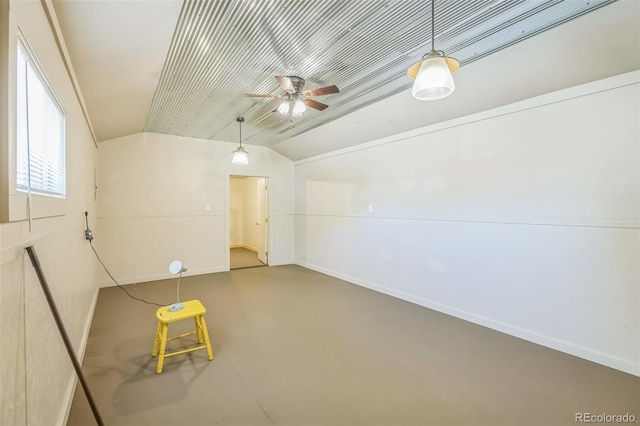bonus room with concrete floors, ceiling fan, baseboards, and lofted ceiling