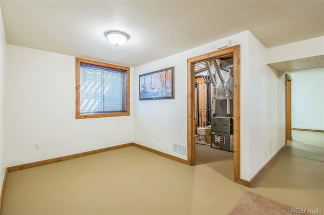 spare room with baseboards and visible vents