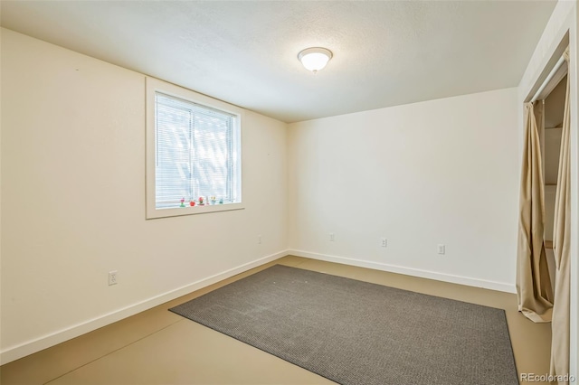 unfurnished bedroom with baseboards and a textured ceiling