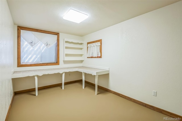 unfurnished office with baseboards