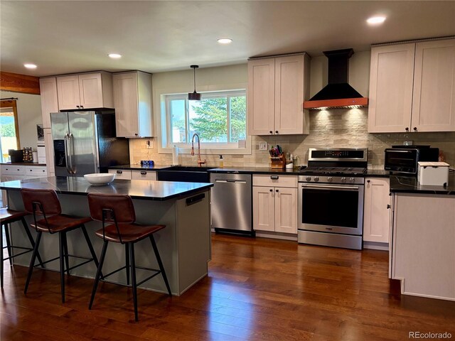 9081 Range Ln, Salida, CO 81201 - kitchen with appliances with stainless steel finishes, wall chimney range hood, dark countertops, plenty of natural light, and recessed lighting