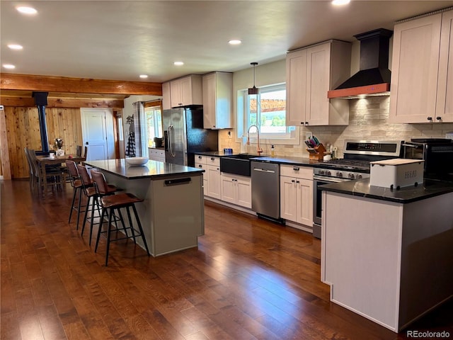 9081 Range Ln, Salida, CO 81201 - kitchen featuring appliances with stainless steel finishes, wall chimney exhaust hood, dark wood-style floors, healthy amount of natural light, and recessed lighting