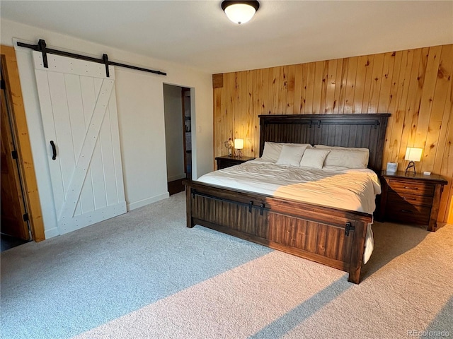9081 Range Ln, Salida, CO 81201 - bedroom with carpet flooring, a barn door, and wood walls