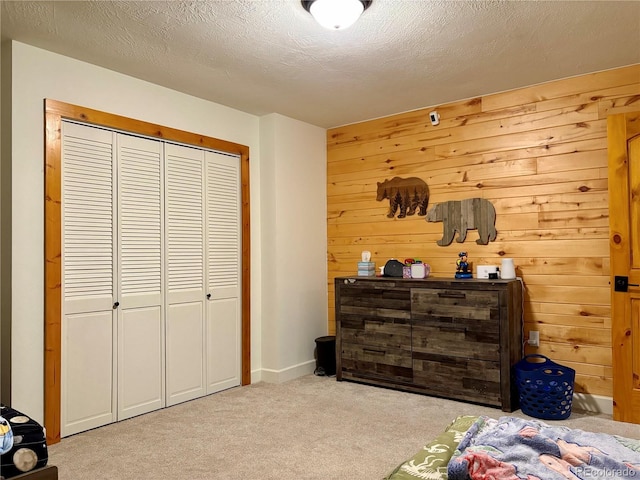 9081 Range Ln, Salida, CO 81201 - carpeted bedroom featuring a closet, a textured ceiling, and wooden walls